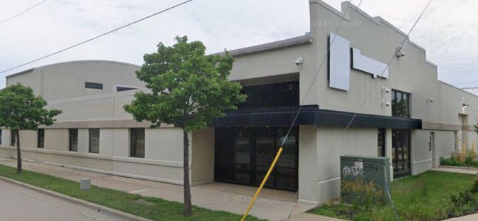 Single-story commercial building with a dark canopy entrance and blank sign panel at 2030 Pennsylvania Avenue.