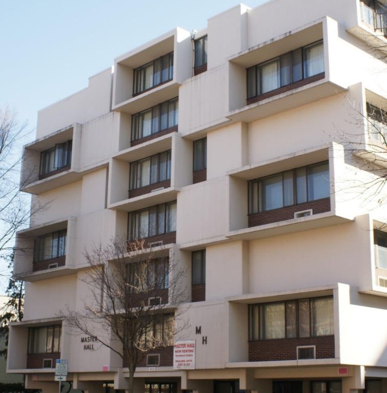 Master Hall apartment building at 415 West Gilman Street, a mid-century modern white concrete structure.
